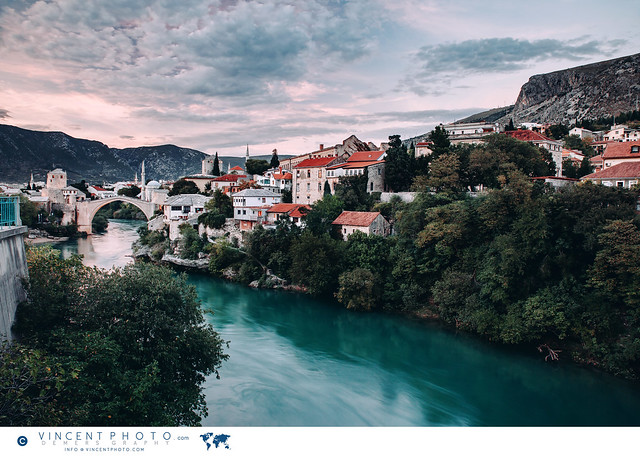 View on the city of Mostar with the Stari Most old bridge and the Neretva river surrounded by mountains in Bosnia and Herzegovina.