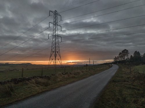 Ferenze Raod Sunset by Allan Ogg, The sun setting over the Firth of Clyde from Fereneze Road above Neilston.road pylon eastrenfrewshir