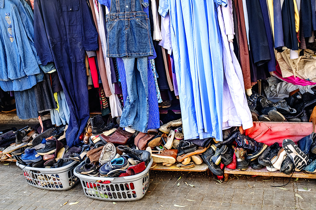 Used clothing and shoes for sale on sidewalk near bus and van terminal on 12-8-20--Beirut