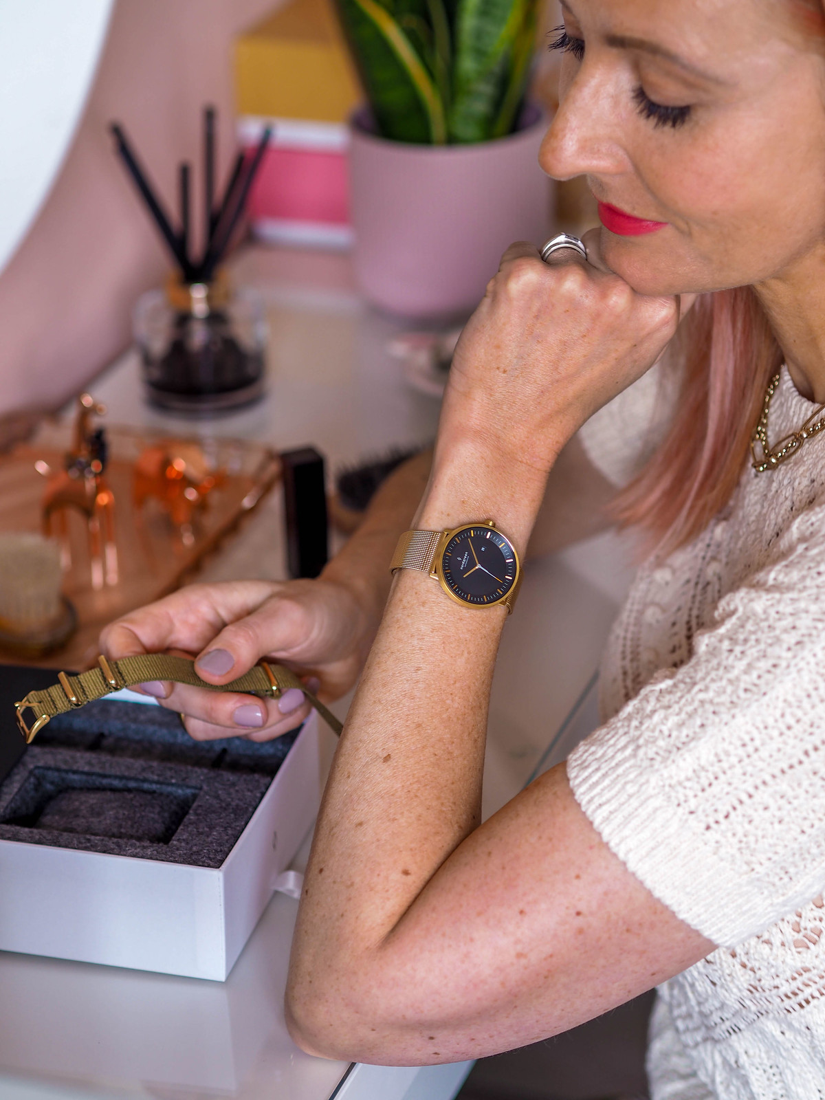 A Classic Black and Gold Watch With Ethical, Sustainable Credentials (Catherine Summers AKA Not Dressed As Lamb is sitting at her dressing table showing off her Nordgreen watch)