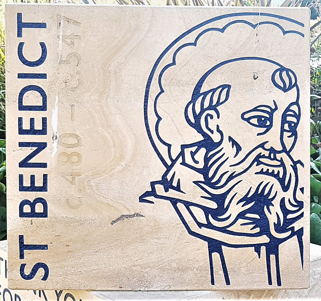 A limestone block outside Gloucester Cathedral depicting St. Benedict AD480-AD547.