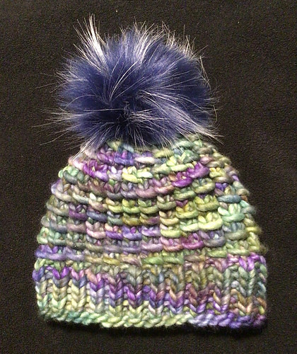 Natalie (abrnat) loves the Arteixan Hat by Kristel Nieves that she knit with the Malabrigo Rasta and pompom she won in my last draw!