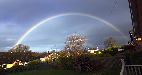 rainbow betwsynrhos conwy northwales greatbritain uk unitedkingdom flickrnature december2020 welshcountryside rurallandscape bungalows houses trees red yellow green indigo magenta sky fences overheadelectriccables telegraphpoles telephonewires grass lawns shrubs
