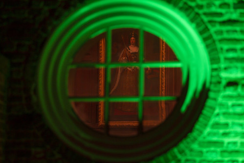 A portrait of Queen Mary II can be seen through the Great Hall window of the Wren Building during the Yule Log Ceremony.