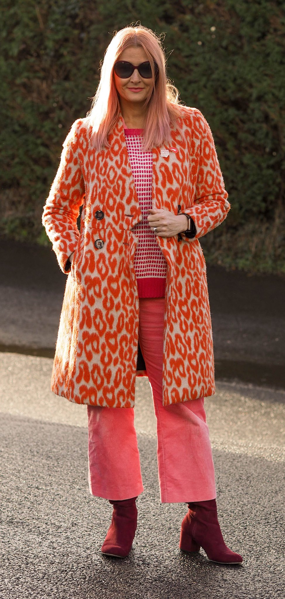 An Orange, Pink and Red Colour Combination Just WORKS (Catherine Summers AKA Not Dressed As Lamb wearing orange giraffe print coat, pink corduroy jumpsuit, red and white patterned sweater and burgundy boots)