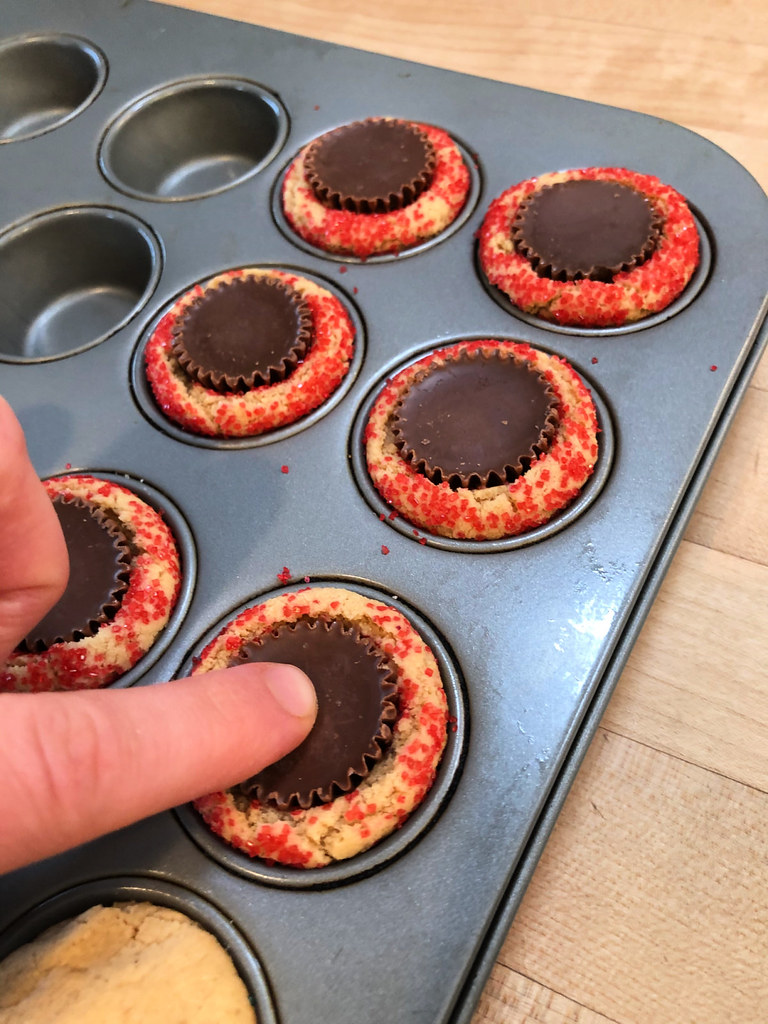 press a peanut butter cup into each cookie