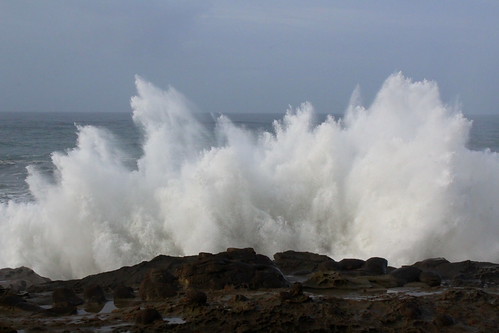 A wave crashes up against the coastal cliffs by rozoneill, Shore Acres State Park, Charleston, Oregon USAcape arago shore acres sunset bay oregon state park ch