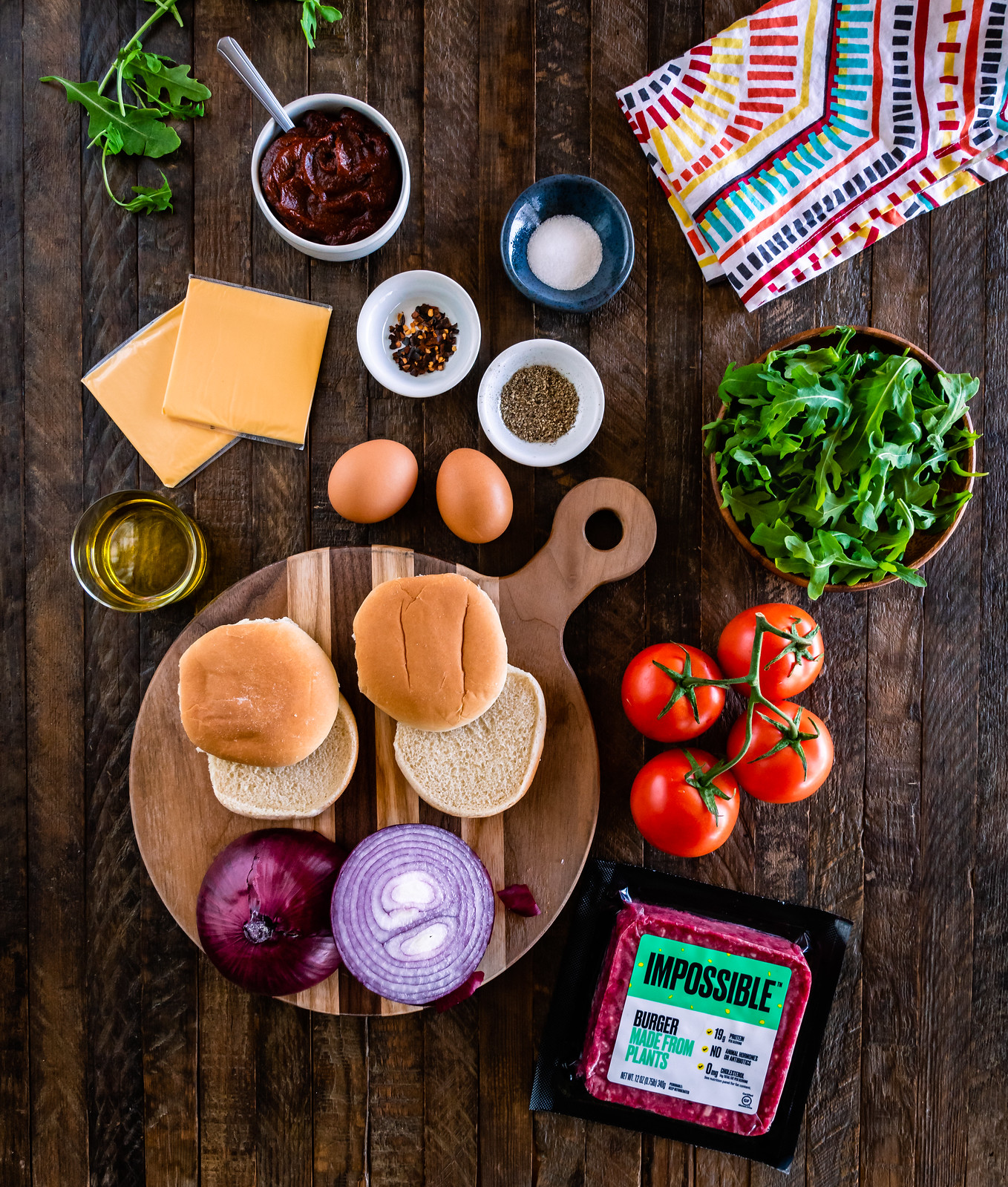 a spread of colorful ingredients to make impossible breakfast sliders