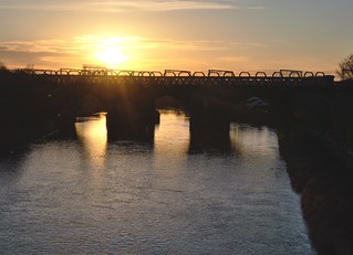 The Sun sets over the railway bridge at Preston