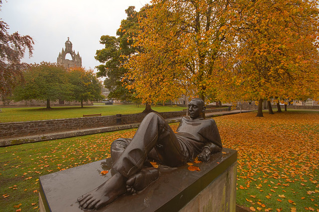 Memory of autumn rain - reclining student with King's College in the background. University of Aberdeen, Aberdeen, Scotland.