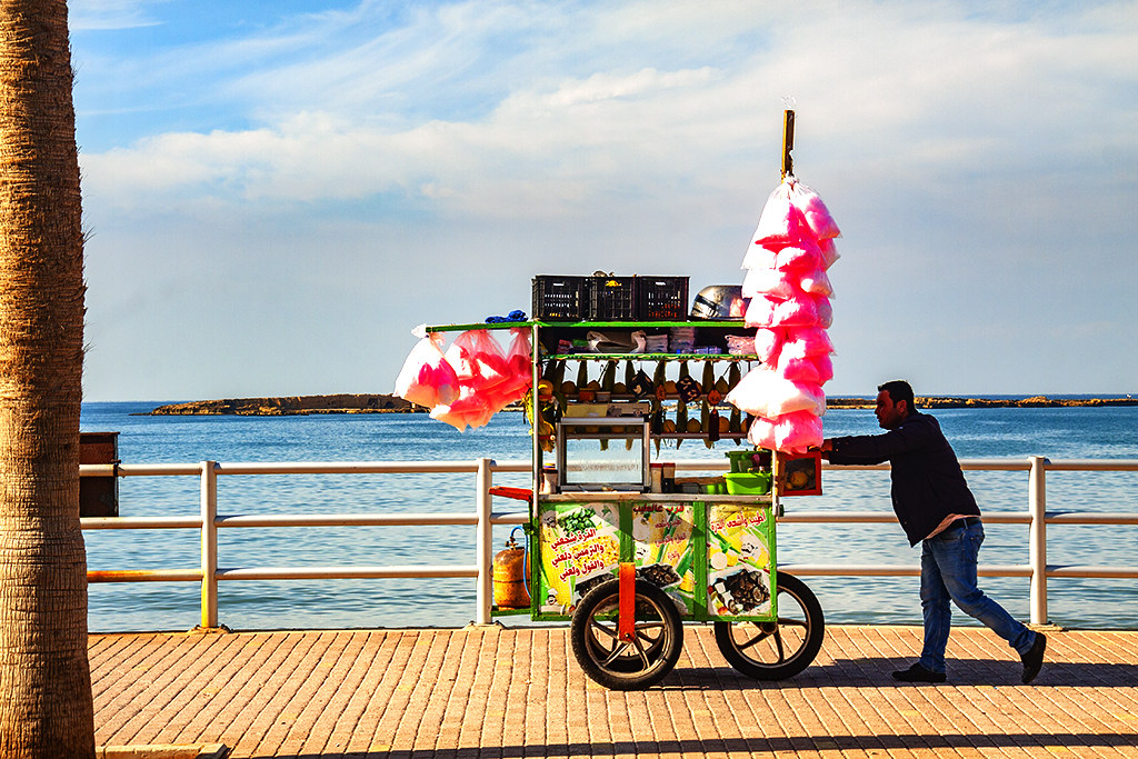 Man selling fruits and cotton candies by seashore on 12-28-20--Sidon