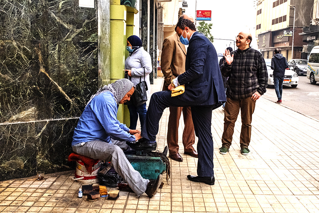 Suited man getting a shoeshine on Talaat Hab on 12-30-20--Cairo