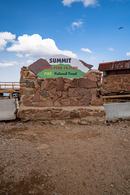 Colorado, USA - September 15, 2020: Sign for the Pikes Peak National Forest mountain summit. Heavy construction in background