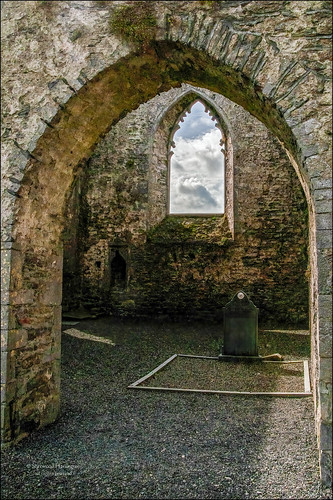 ireland laois aghaboe abbey ruin grave window clouds