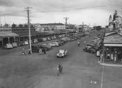 bundaberg landscape buildings bicycle motorvehicles streets powerpoles people shops parked cars bourbong street state library queensland collection