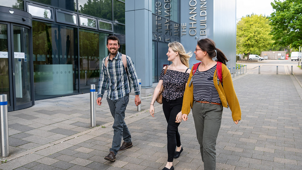 Three students walking through our campus