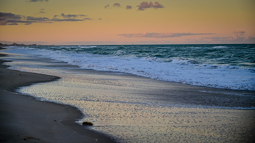 melbournebeach florida unitedstates beach during dusk along atlantic ocean melbourne fl fla water sea surf wave sand sunset orange yellow clouds