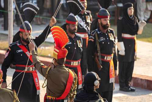 Amritsar India- Febuary 8, 2020: Indian Border Security Force and Pakistan Rangers (black uniforms) lower flags at Wagah Border Closing Ceremony. Focus on the Border Security Force (Brown Uniform) | by m01229