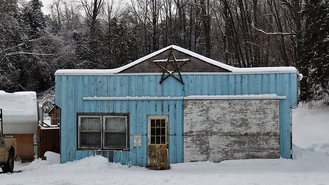 Pastel blue board-and-batten building, with star, Horning's Mills, Dufferin County, Ontario..