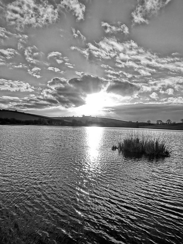 sunset on kernan with dark clouds in black and white