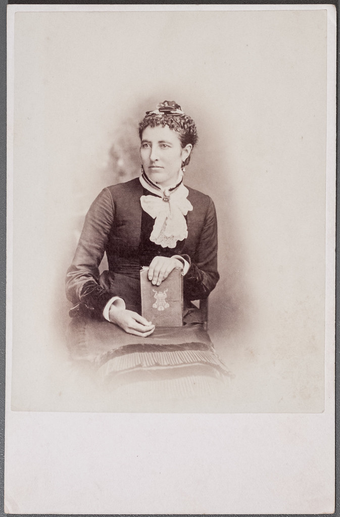 Cabinet card portrait of a woman with a book