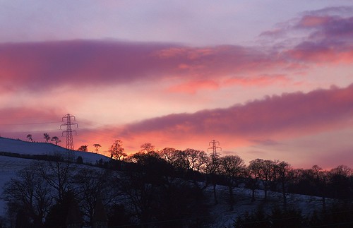 sunset betwsynrhos conwy northwales greatbritain uk unitedkingdom flickrnature canon canoneos1200d january2021 trees magentasky red magenta purple orange redsky orangesky yellowsky pink pinksky pinkglow redglow yellowglow pylons electriccables overheadelectriccables overhaedelectricwires snowscape snow hedgerows welshcountryside welshlandscape tamron28300mmlens