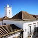 edificios y torre campanario exterior Iglesia Santa Maria del Castillo de Tavira Algarve Portugal