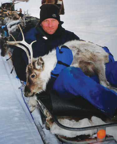 Researcher Karsten Schnider cradles an exhausted reindeer. Photo: Mervyn Aitchison. From A Life of Extremes - The Life and Times of a Polar Filmmaker: In Search of the Sami.