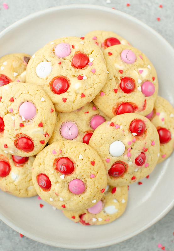 Valentine's Day cookies with pink, red, and white M&Ms and heart sprinkles