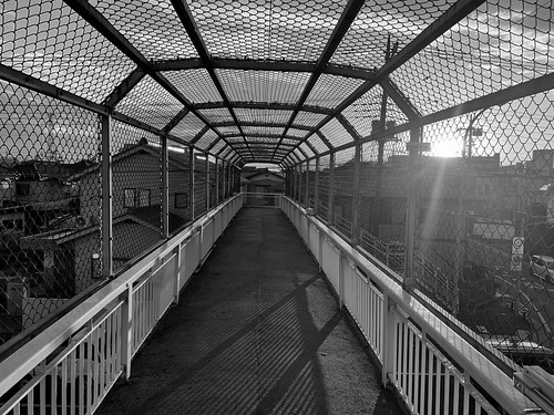 fence backlit pedestrianbridge bw blackandwhite sunset sky hidesax apple iphone xr