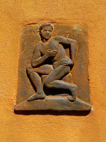rusted plaque on a yellow wall in Køge, a medieval town in Denmark