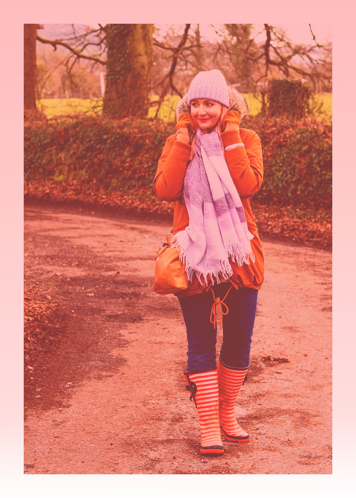 The Importance of Bright Accessories in Cold Weather | Catherine Summers of Not Dressed As Lamb, Over 40 Fashion, wearing burnt orange parka, lilac beanie and scarf and blue jeans tucked into red striped wellies