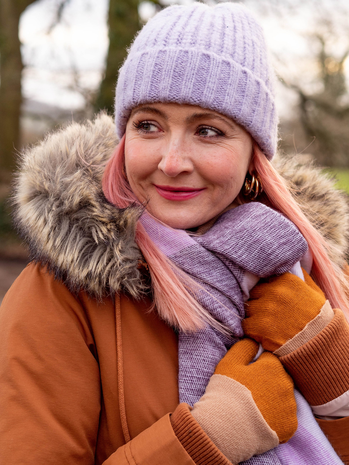 The Importance of Bright Accessories in Cold Weather | Catherine Summers of Not Dressed As Lamb, Over 40 Fashion, wearing burnt orange parka, lilac beanie and scarf and blue jeans tucked into red striped wellies