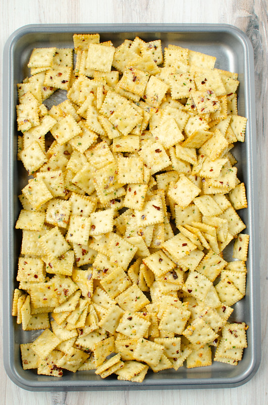 Baking tray of mini Saltine crackers in a buttery spicy ranch sauce