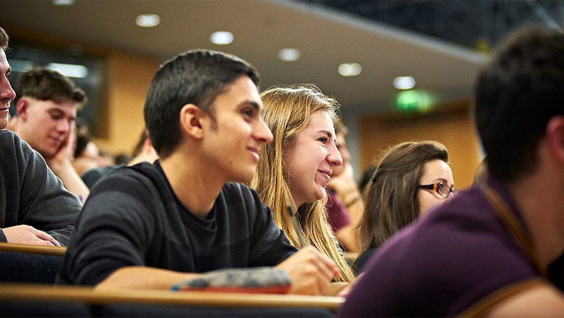 International students studying together in a lecture theatre