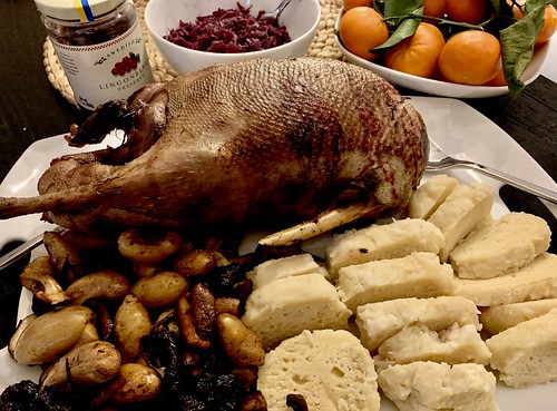 Photo of roasted goose on a plate with other foods