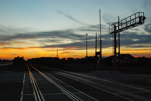 harlem siding sunset twilight dusk hues colors sky rails glint silhouette railroad crossing signal