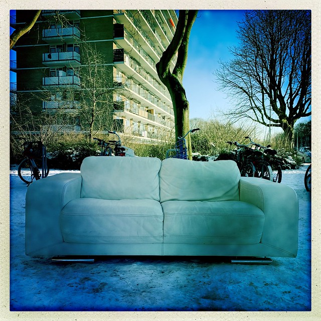 Lost white couch in the snow.