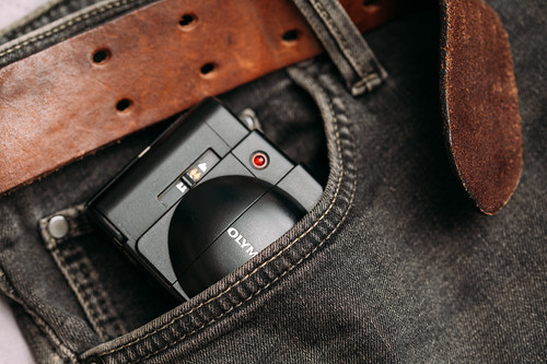 Close-up of a compact camera in a pocket of black jeans | by Ivan Radic