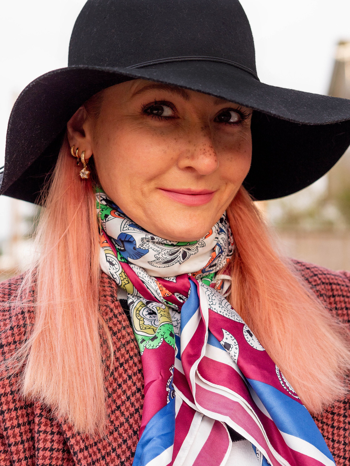 Wearing Black and White a Different Way: Catherine Summers of Not Dressed As Lamb wearing a red check double breasted jacket, black/white striped sweater, multicoloured neck scarf, floppy black hat, white trousers, black lace-up boots | Fashion Over 40
