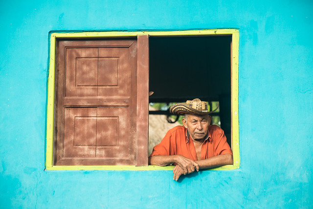 A Colombian man looks from his window in El Salado