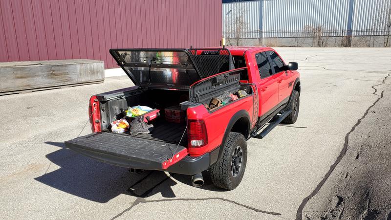 An Aluminum Truck Bed Cover On A Dodge Ram with Ramboxes