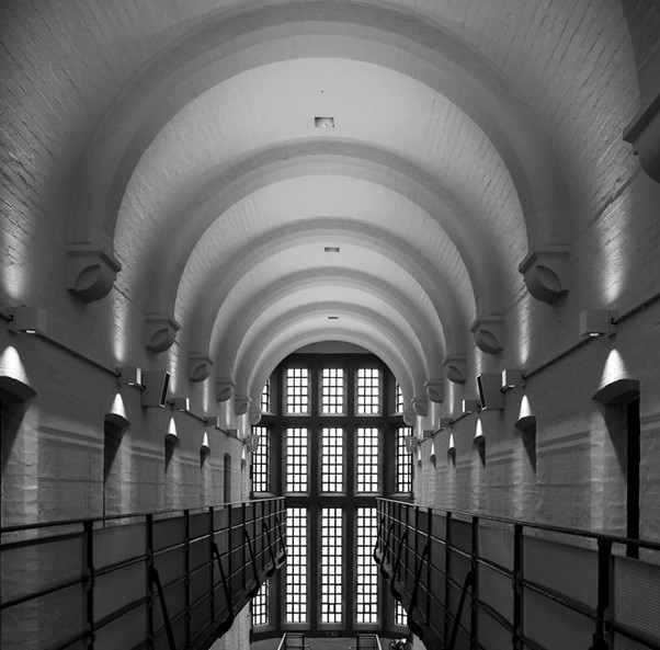 A black and white photograph of a victorian style prison in the UK