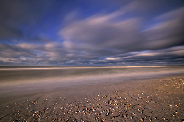 Long exposure of shells in the sand and clouds just after sunrise on Bowmans Beach on Sanibel Island, Florida