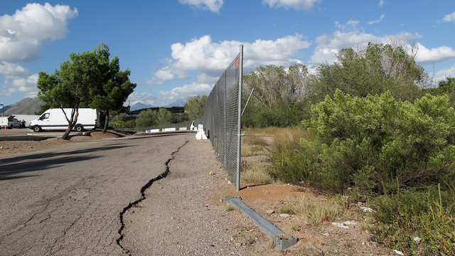 A chainlink fence to separate truckstop civilization (left) from the frightening wilderness of the Chihuahuan Desert (right).
