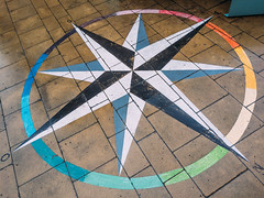 Close-up of a compass graffiti on the ground