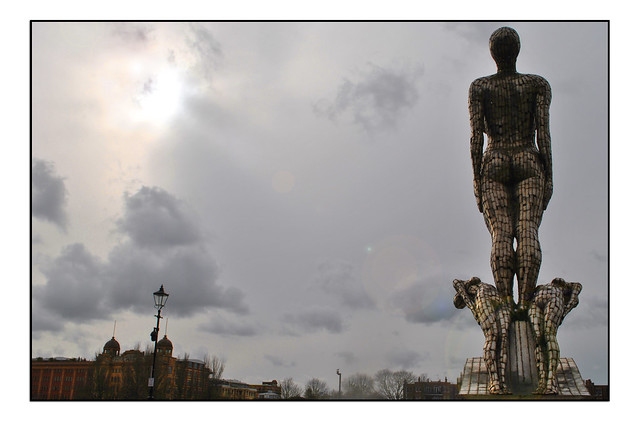 THAMES PATH STATUE AGAINST A GREY LATE WINTER SKY