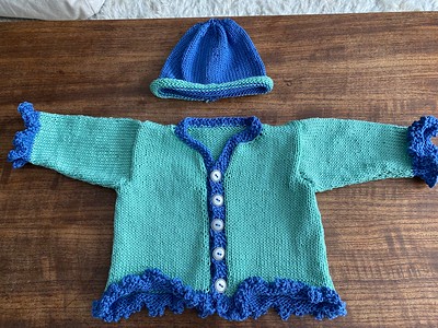 Laura knit these two sweater sets for 6-12 months great niece and nephew using El D Mouzakis Butterfly Super 10 cotton yarn.