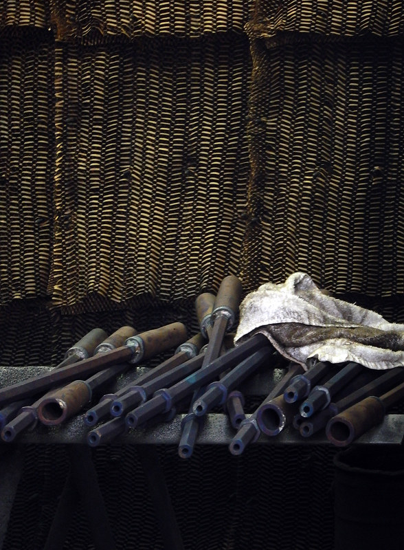 Dark tools and a white rag in a metal shop on Granville Island in Vancouver