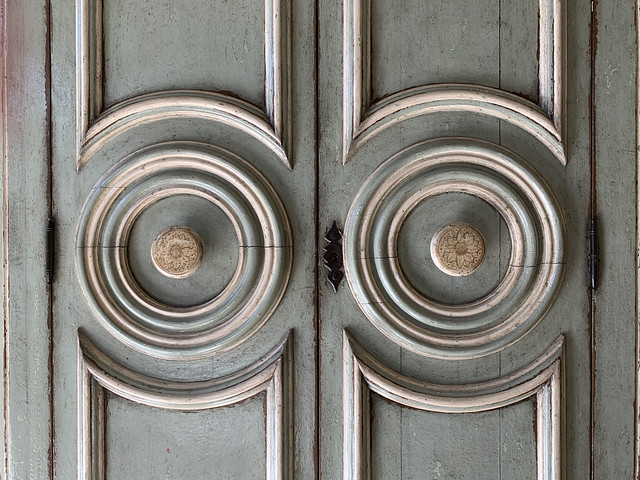 A pair of old doors with circle design